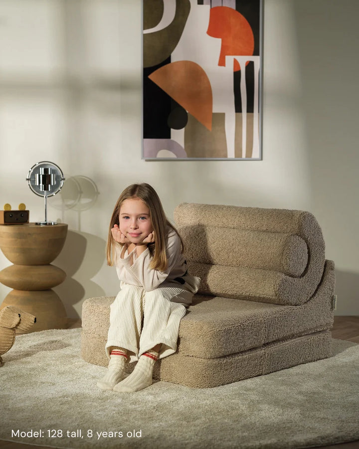 Child relaxing in Wigiwama Biscuit Flipster in a cosy home interior