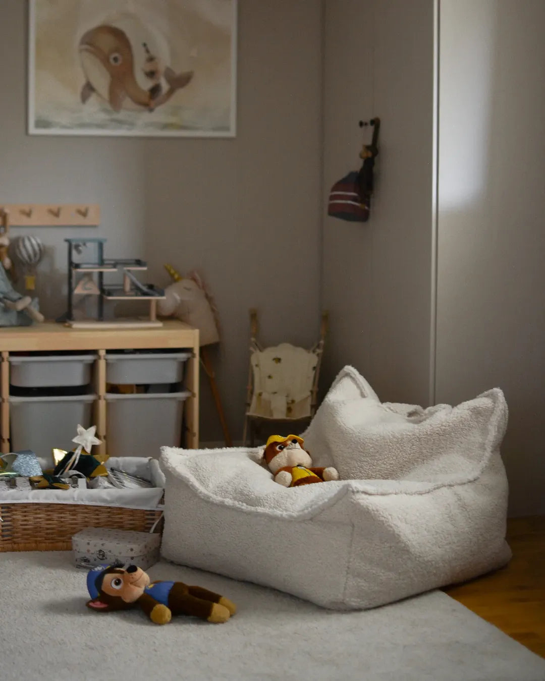 Wigiwama teddy beanbag creating a cosy reading nook in a Montessori-style kids room with soft lighting