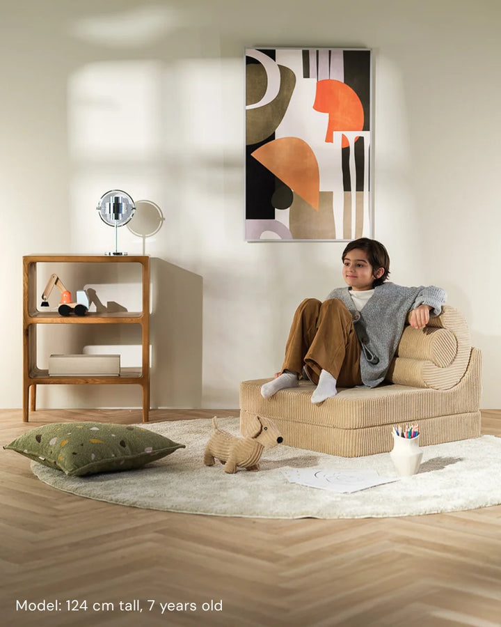 Child relaxing in Wigiwama Brown Sugar Flipster in a cosy home interior
