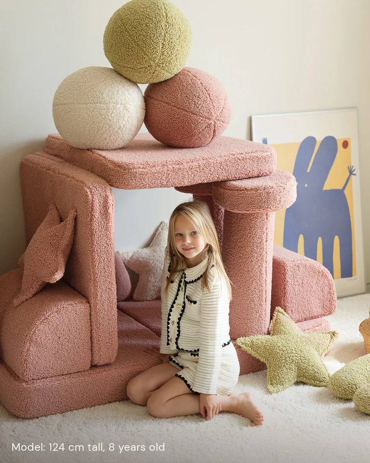Child relaxing in Wigiwama Guava Settee in a cosy home interior