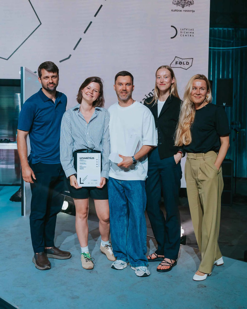 The Wigiwama team with designer Mark Litvyakov celebrating the Moon Chair’s win at the National Design Award of Latvia 2025, posing with the winner’s certificate.