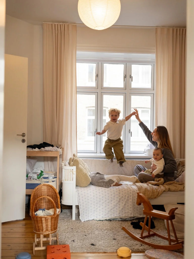 Lea Sørensen at home in Copenhagen with her two sons, sharing a playful moment in their cosy, light-filled kids’ room.