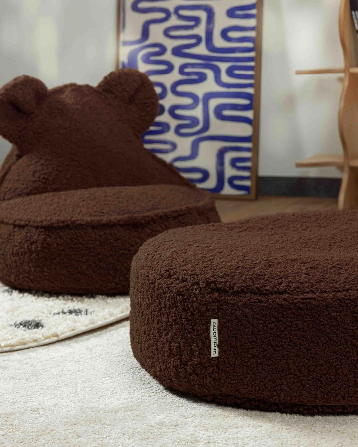 Brown plush bean bag chairs with a visible brand logo on a light-colored floor.