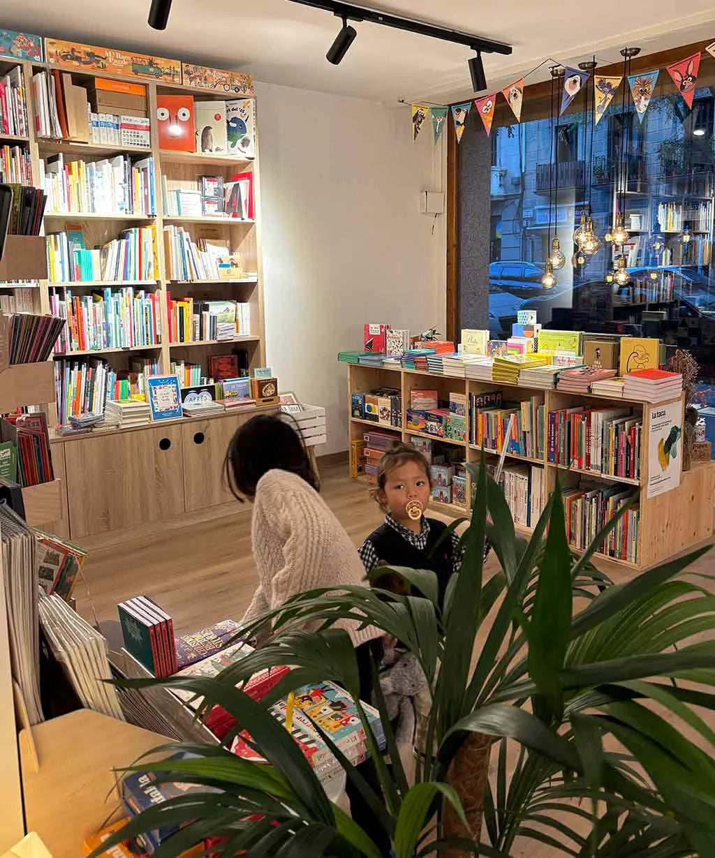 Children in a library surrounded by bookshelves and books