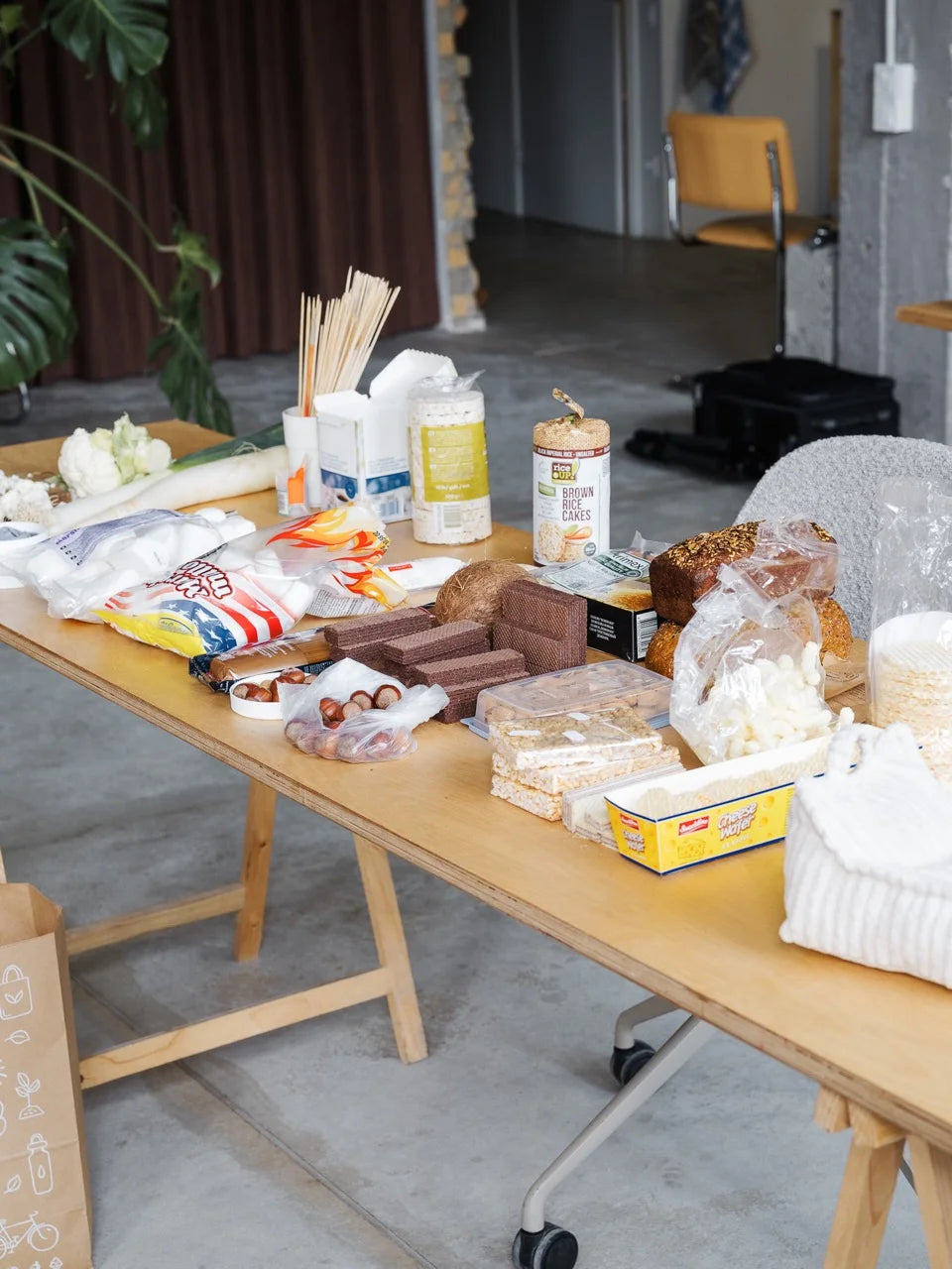 Studio table filled with styling elements — rice cakes, cauliflower, marshmallows and interior materials used in the shoot.