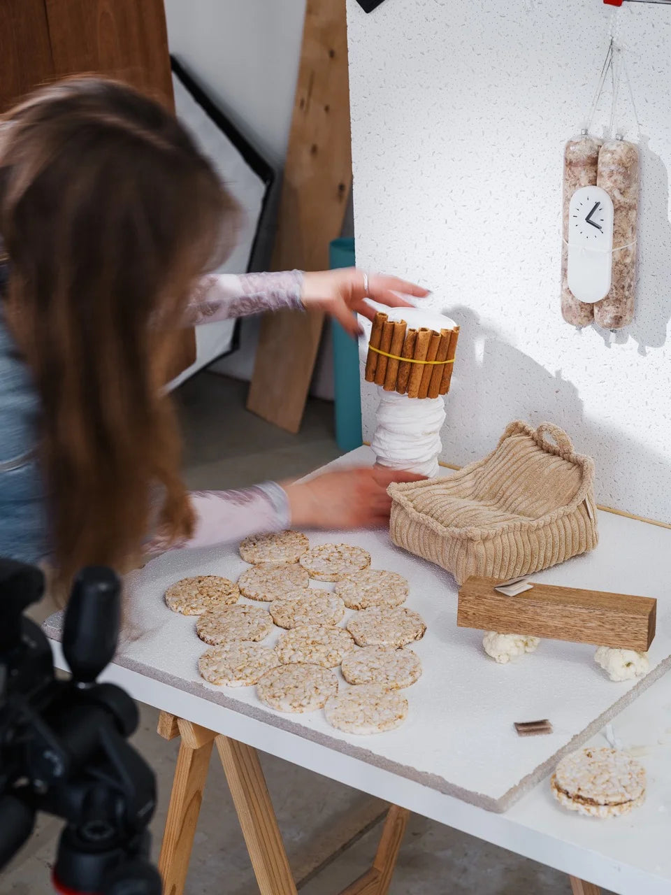 Behind the scenes: Zane arranging cinnamon, rice cakes and a Mini Beanbag during the photoshoot setup.